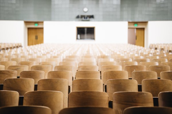 empty chairs in college auditorium style business ethics class discussing the Effectiveness of Professional Ethics Education studies can be to the student. Photo by Nathan Dumlao on Unsplash