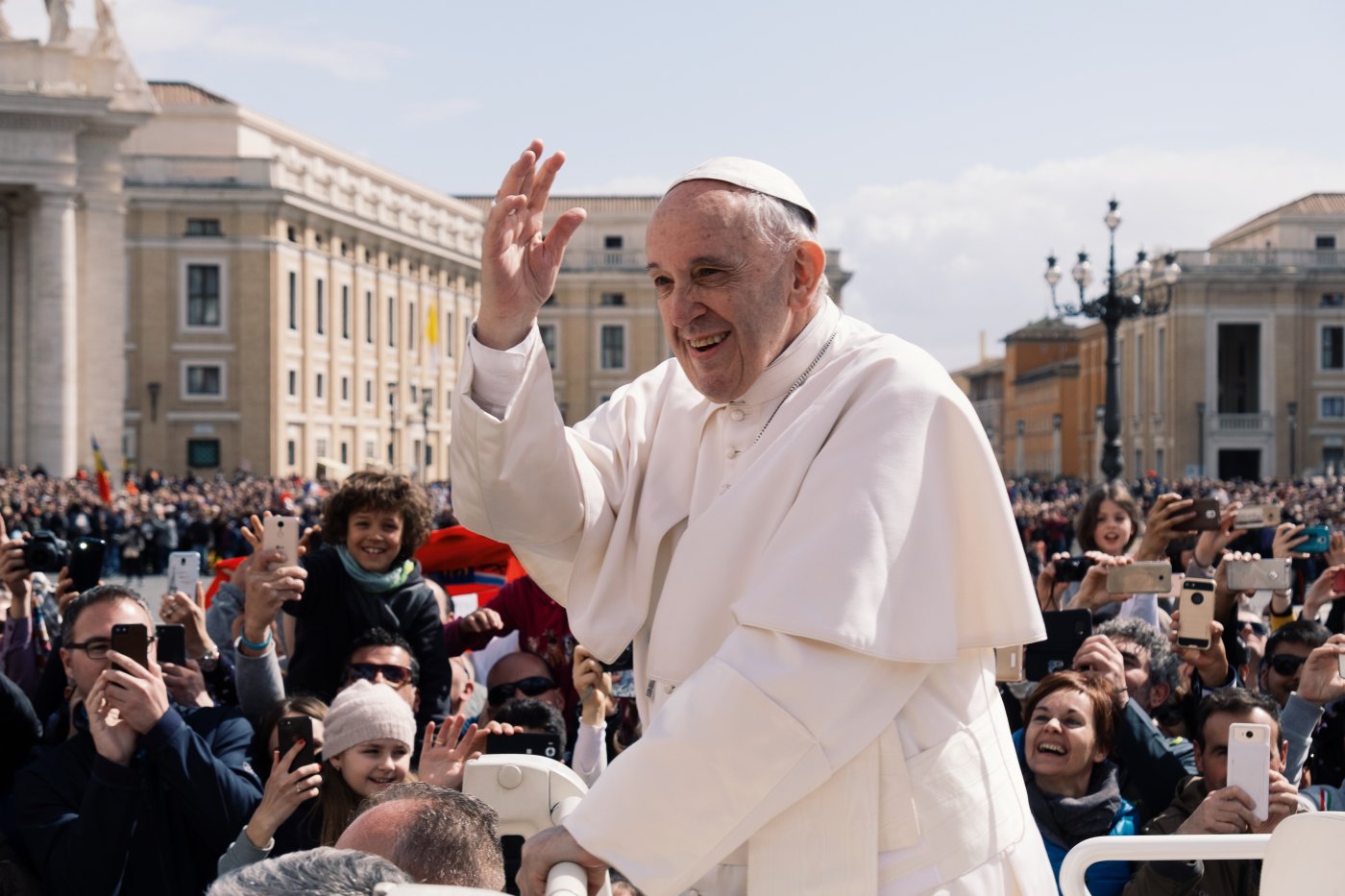 Pope Francis is waving to his constituents giving a talk about how gossip can be detrimental to positive corporate culture.