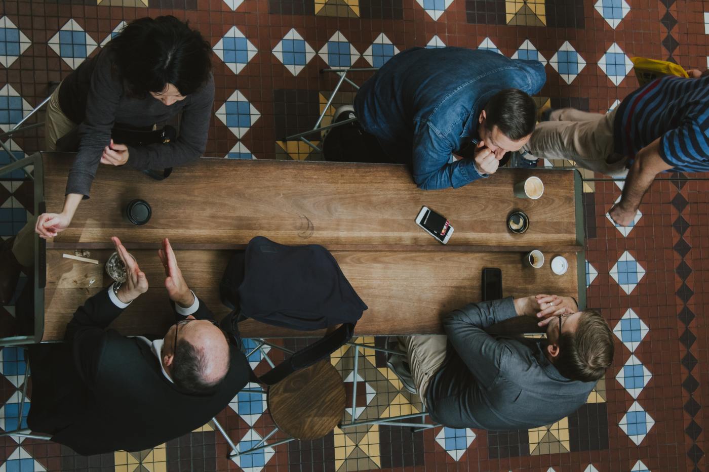 Overhead view of 4 people having discussions at a table in Arbitration